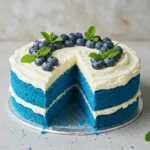 Close-up of a slice of Blue Velvet Cake with cream cheese frosting