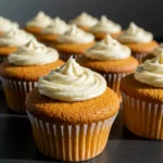 Moist vanilla cupcakes fresh out of the oven with creamy frosting
