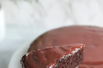 Delicious rich chocolate cake topped with chocolate frosting and sprinkles